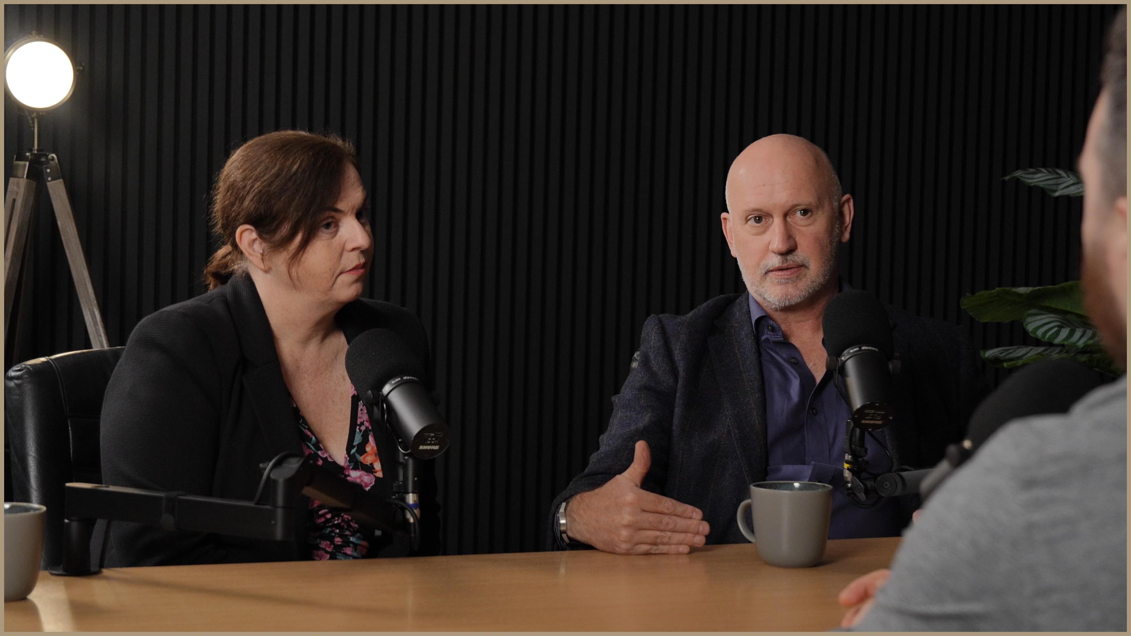 Landing page header, two people talking on a podcast.